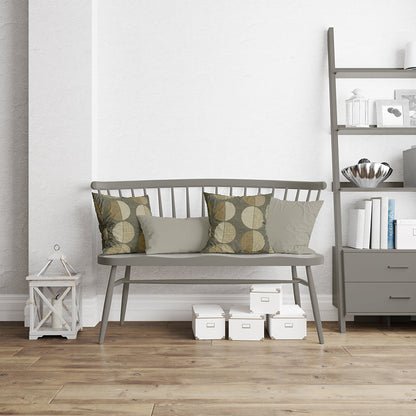 Gray seating upholstered in oxide geometric fabric NJ25-376 with olive patterned cushions, in a living room with a shelf and a lantern.