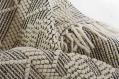 Chunky cream & charcoal woven rug with looped fringe, 2' x 3'.