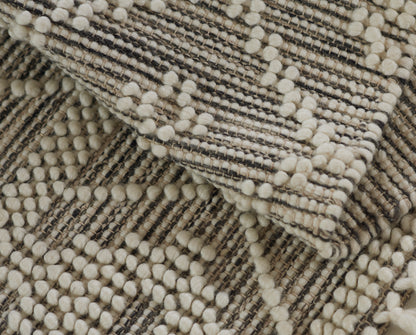 Beige cream boucle weave with tan-brown stripes and soft pom-pom texture; 2' x 3' rug.