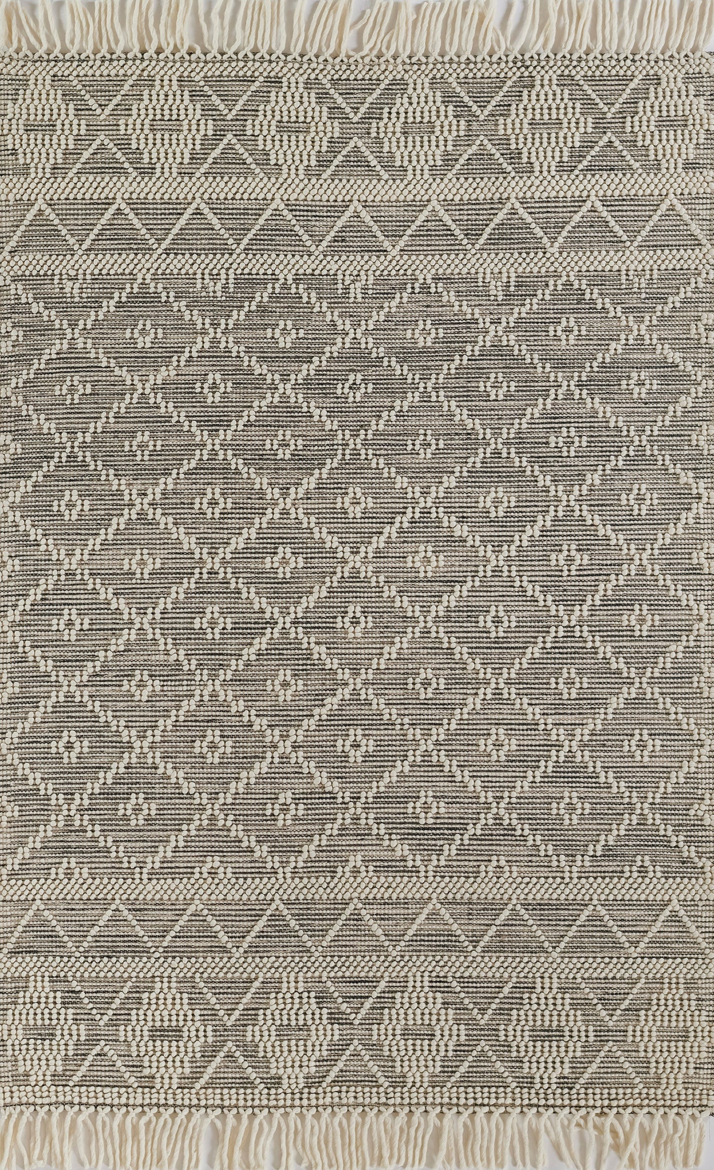 Neutral woven rug in cream and taupe with diamond lattice pattern and fringed ends; boho kilim style.