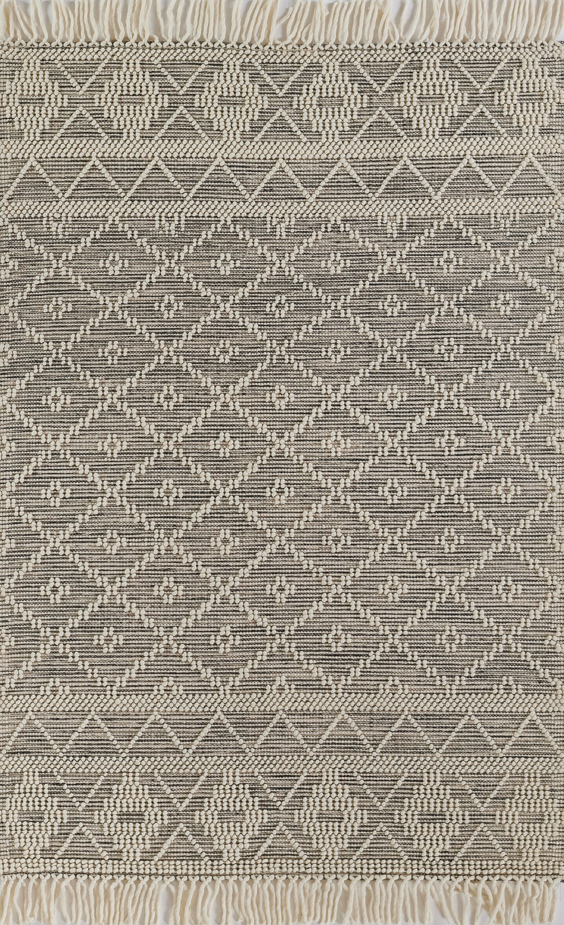 Neutral woven rug in cream and taupe with diamond lattice pattern and fringed ends; boho kilim style.