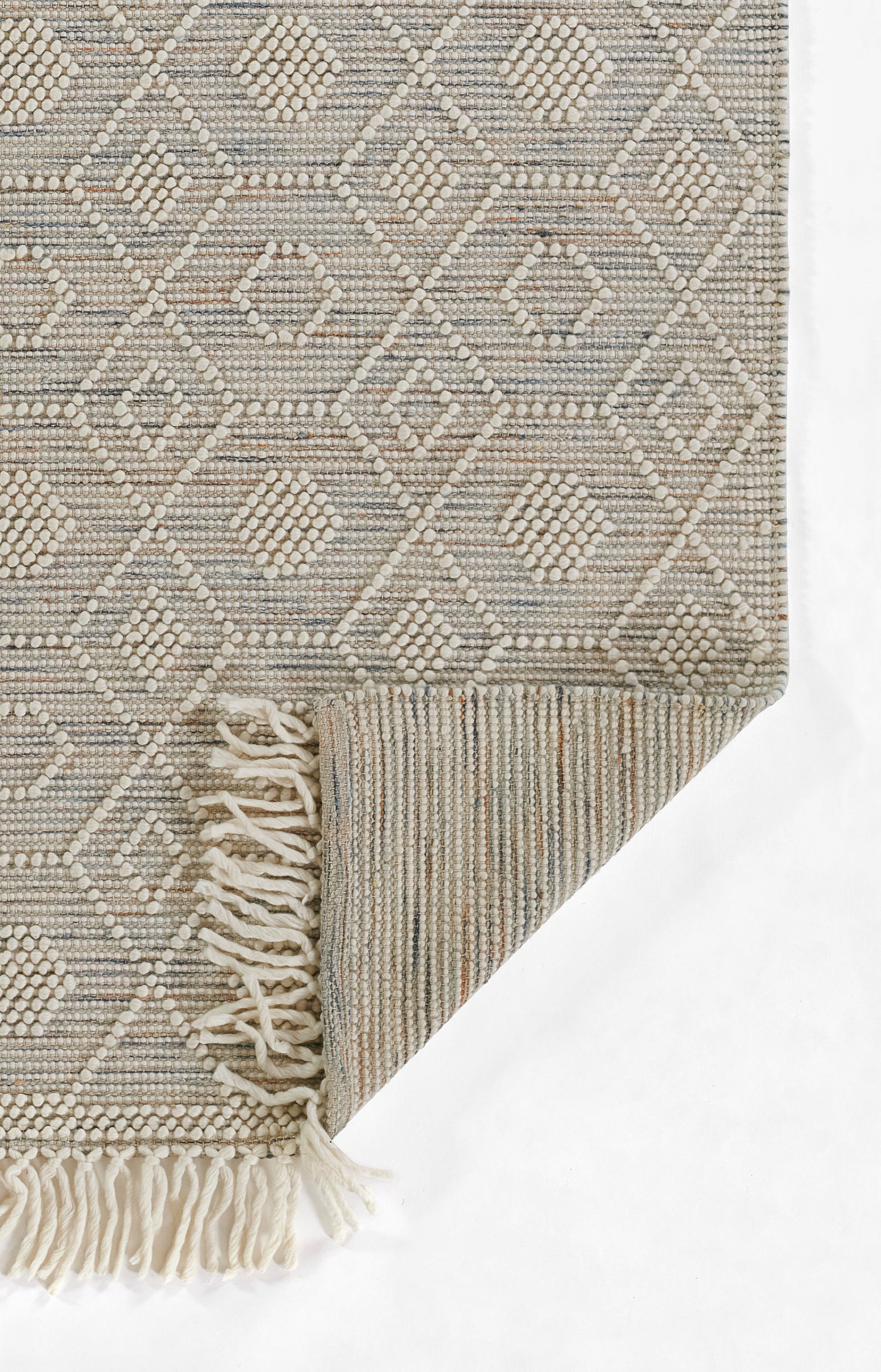 Neutral beige-gray woven runner with diamond geometric pattern, textured loop weave and fringe tassels along edge.