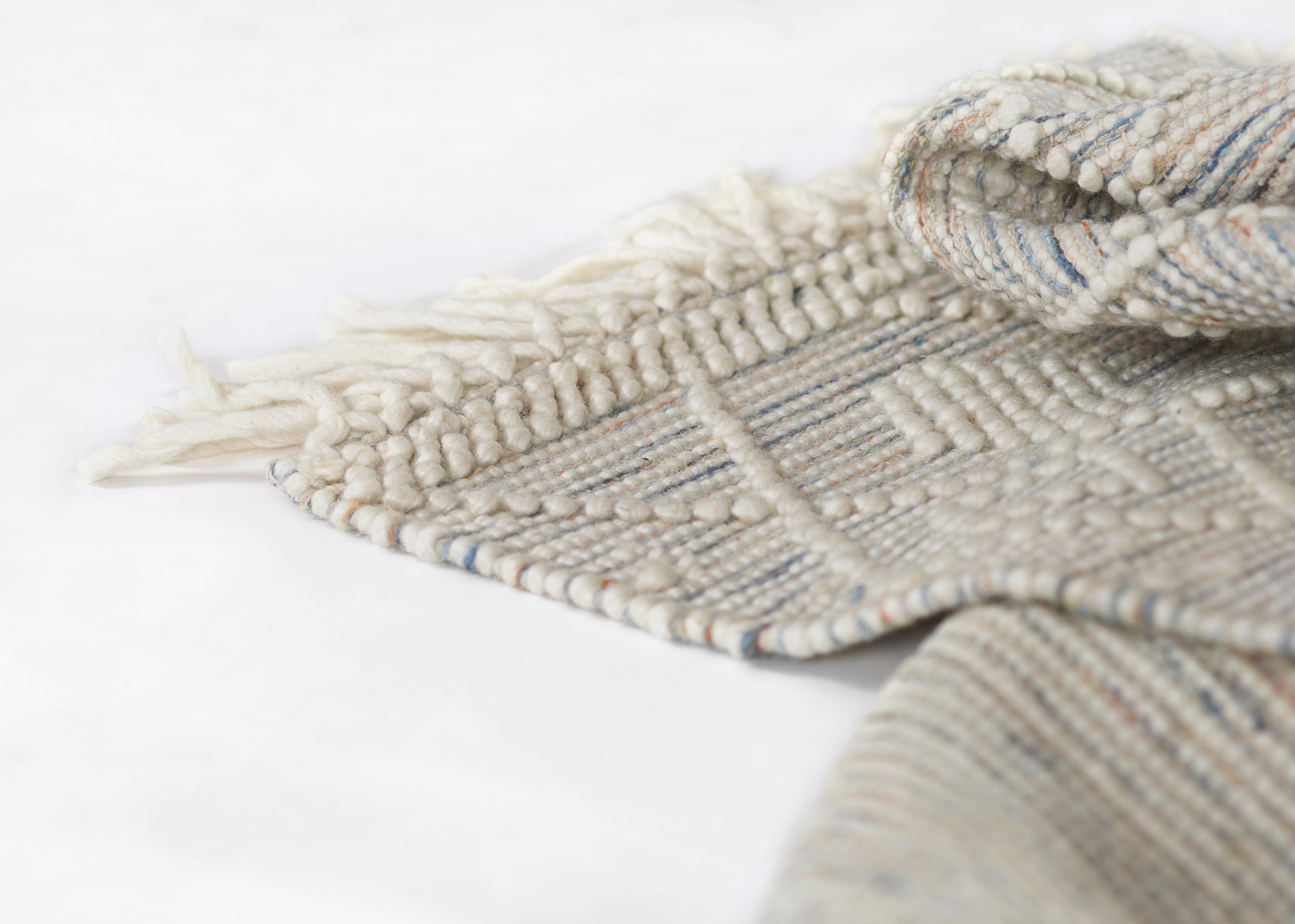 Neutral woven 2' x 8' runner rug with fringed edges, cream and beige tones, blue-gray stripes, wool blend, handmade style.