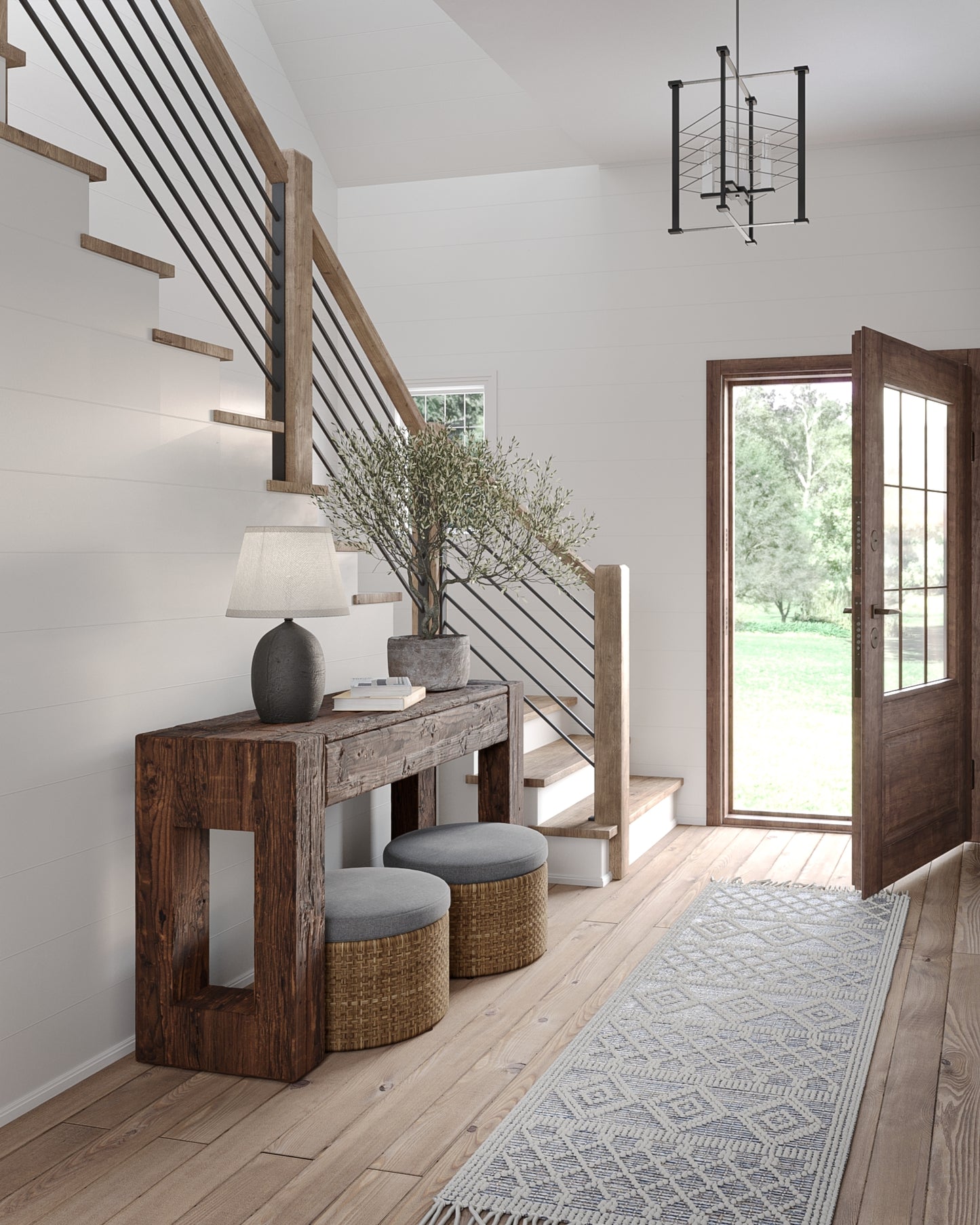 4' x 6' rug on the floor in a room with a rustic wooden console, gray cushioned stools, a potted plant and lamp; white walls, wooden stairs with a black railing visible.
