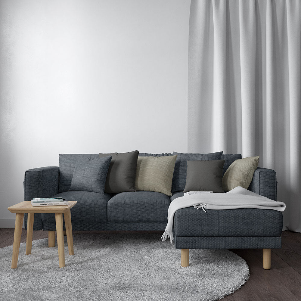 Blue solid tweed fabric upholstery on a sofa in a modern living room.