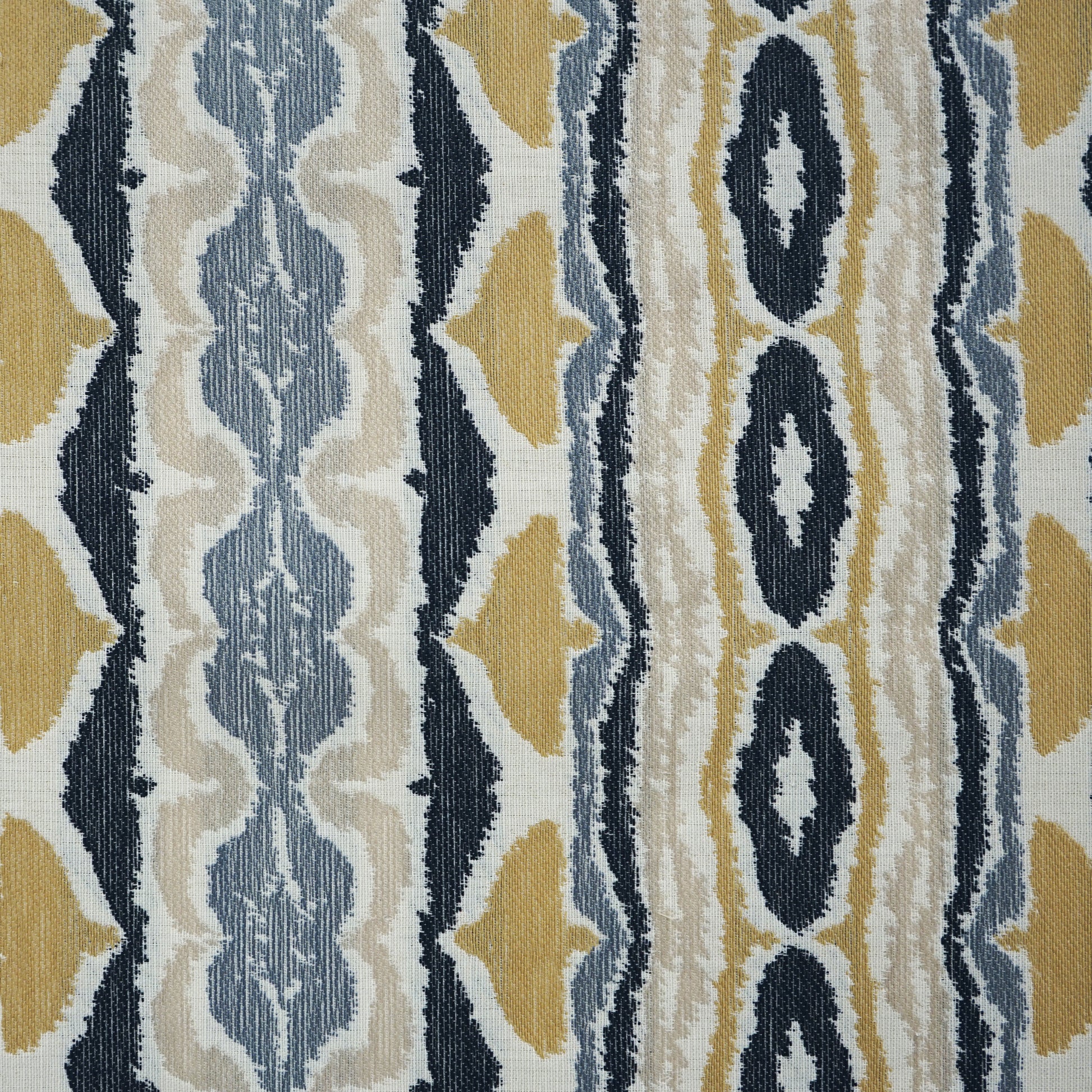 Geometric striped fabric in navy, mustard, light blue and cream with ikat-style diamonds; woven textile.