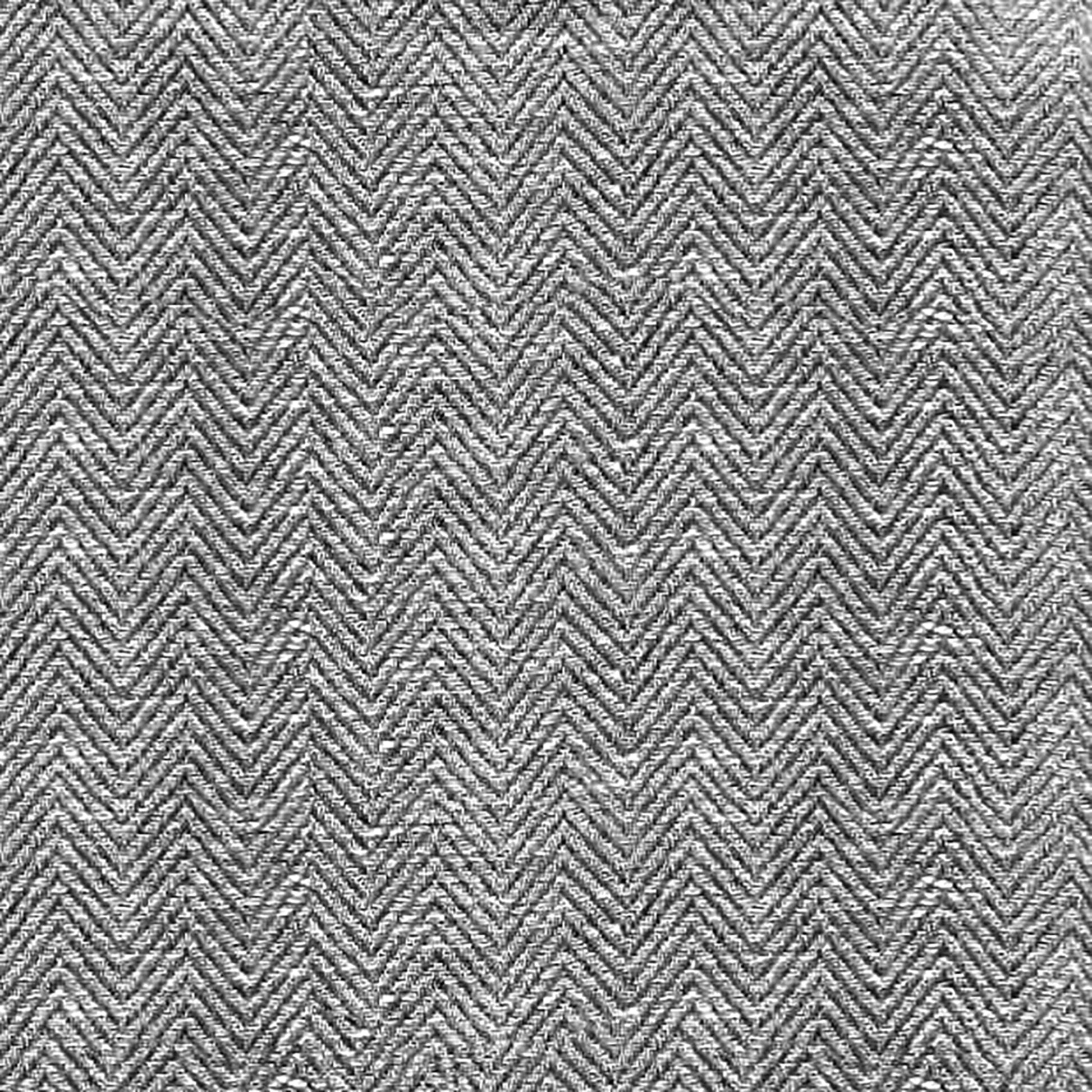 Black herringbone tweed fabric close-up with textured chevron weave.