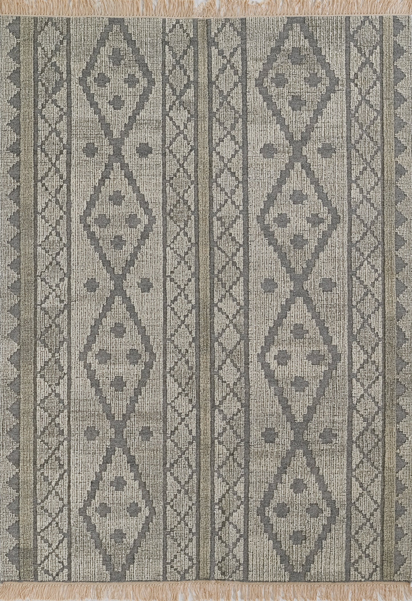 Gray and beige geometric striped rug with diamond medallions, lattice borders and fringed ends.