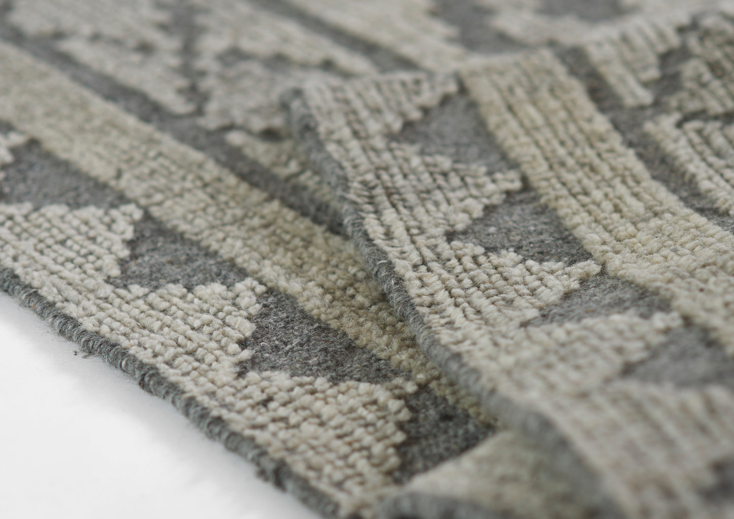 Gray and ivory geometric patterned rug with soft, textured pile; rectangular, modern rustic style.