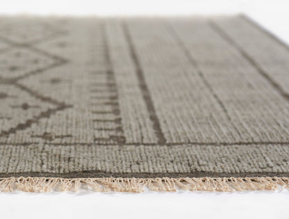Neutral beige-gray woven rug with geometric stripe pattern and fringed edge.