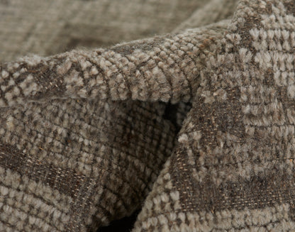 Close-up of brown and beige tweed wool blanket with plaid pattern and soft, fuzzy texture.