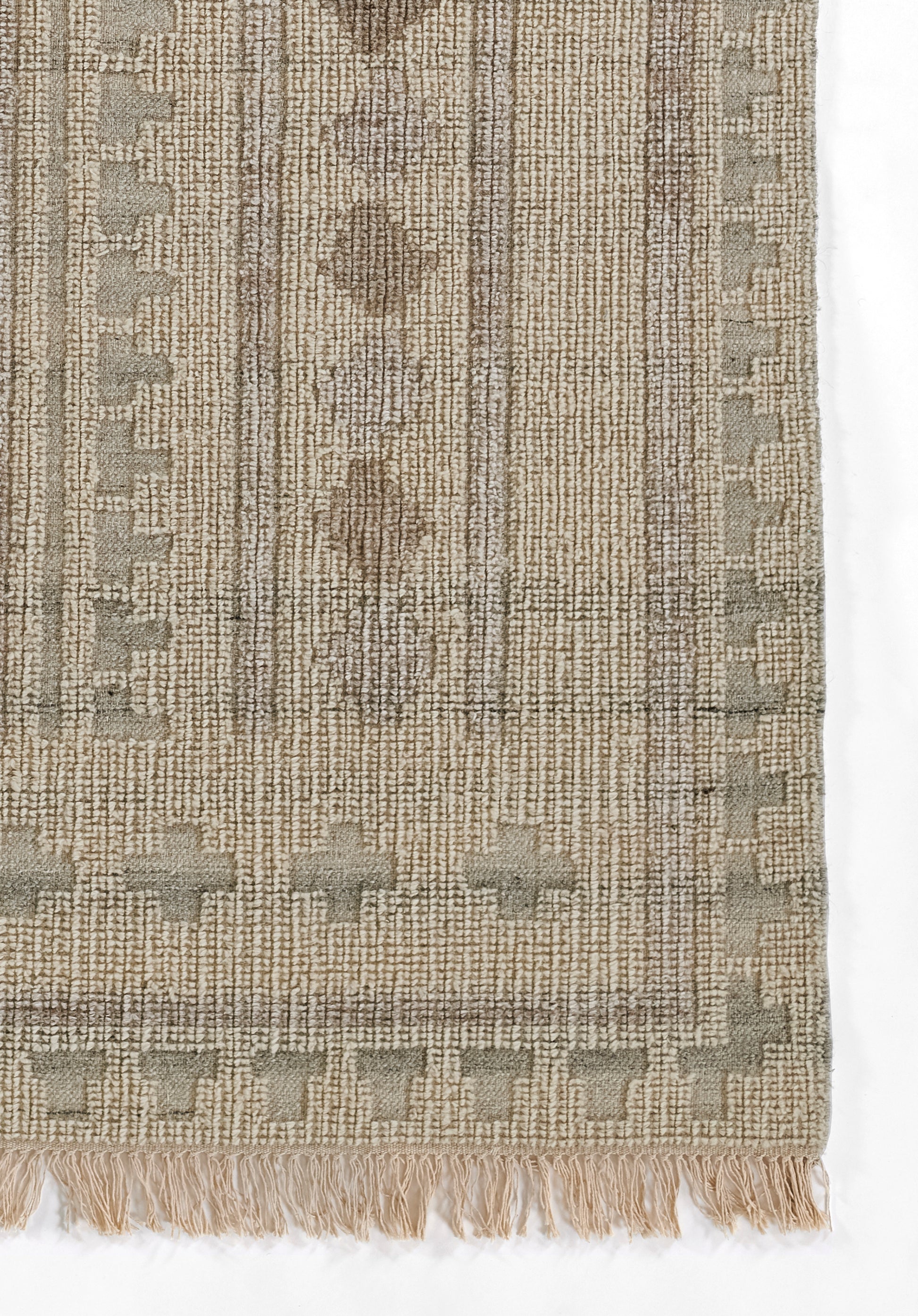 Beige-taupe woven rug with geometric diamond motifs, vertical stripe texture & fringe tassels along the bottom edge.