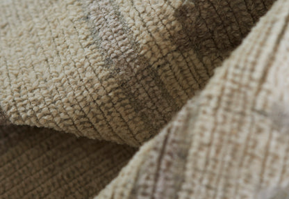 Close-up of beige boucle rug fabric with plush loop pile, folded, showing a soft, cozy 2'3" x 8' runner rug.