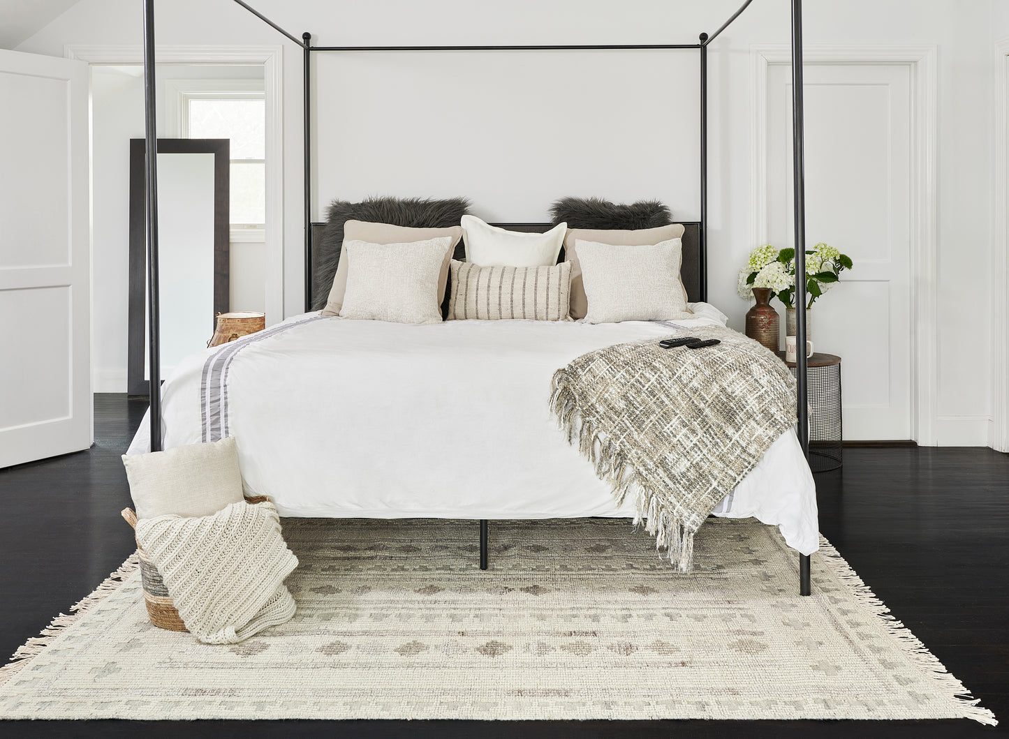 3'6" x 5'6" neutral-toned woven rug in a cozy modern bedroom setting.