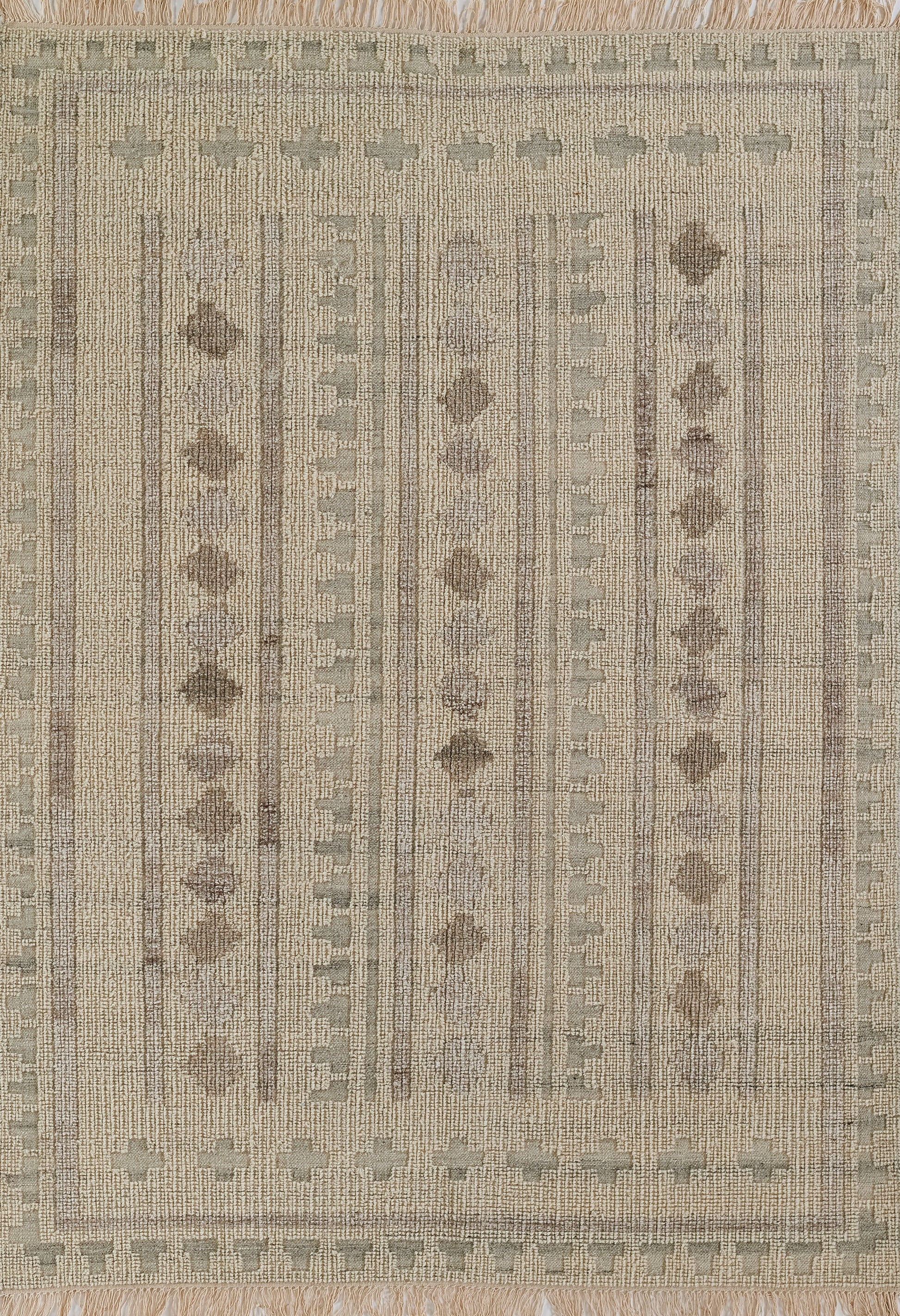 Beige woven rug with taupe vertical stripes and dotted heart motifs; fringed border for a rustic geometric look.