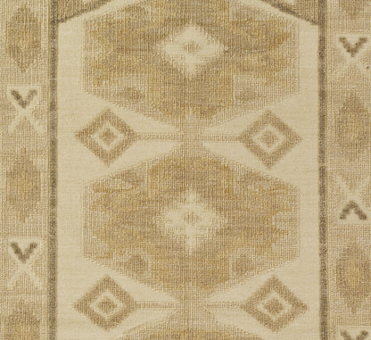 Natural beige flat-weave rug with hexagon and diamond motifs, taupe border, neutral tribal pattern.