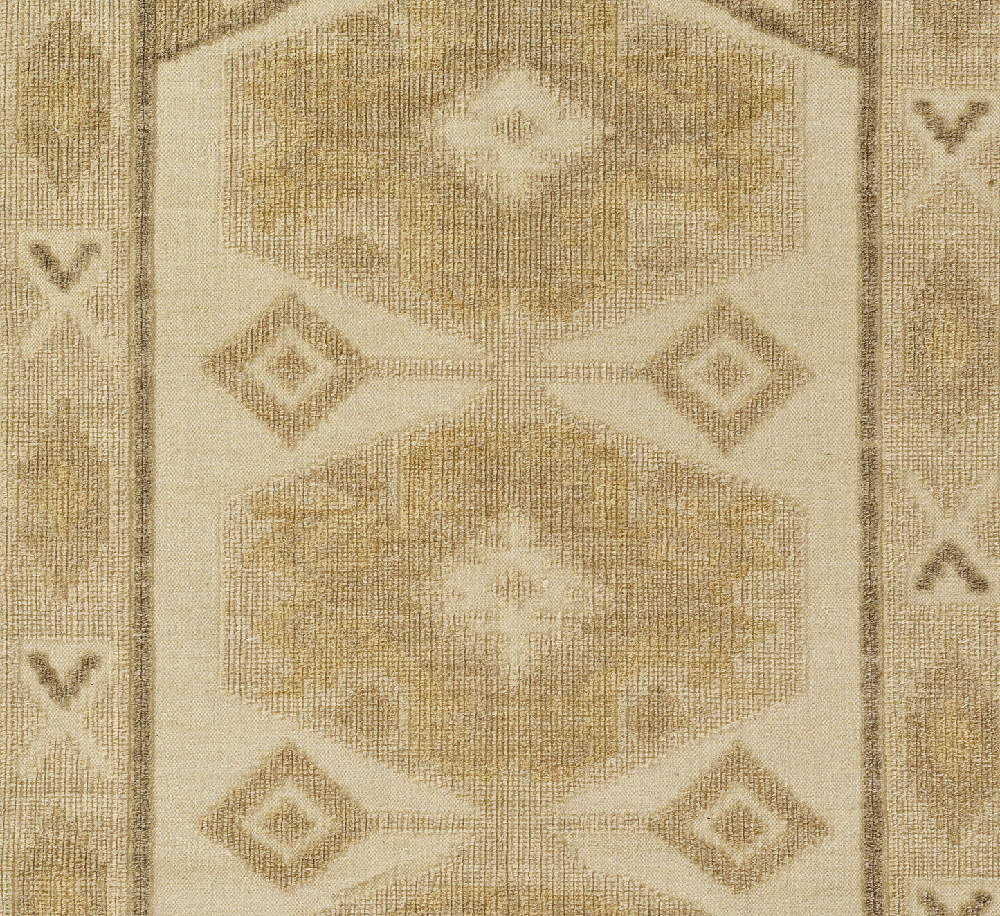 Beige woven rug with geometric hex and diamond motifs in cream and tan, bordered edges