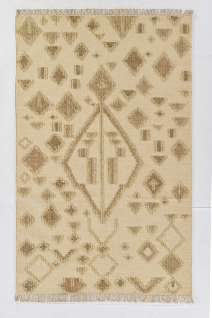 Natural beige kilim rug with taupe geometric diamonds, central diamond motif, and fringe at both ends.