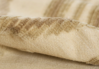 Beige sherpa fleece blanket close-up, fluffy edge and soft knit fabric in natural tan.