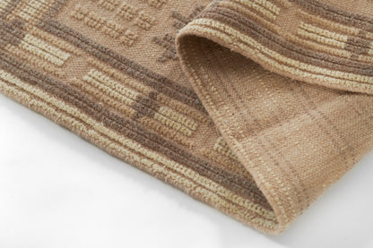 Beige and brown striped rug with geometric motif, plush pile, rolled edge.