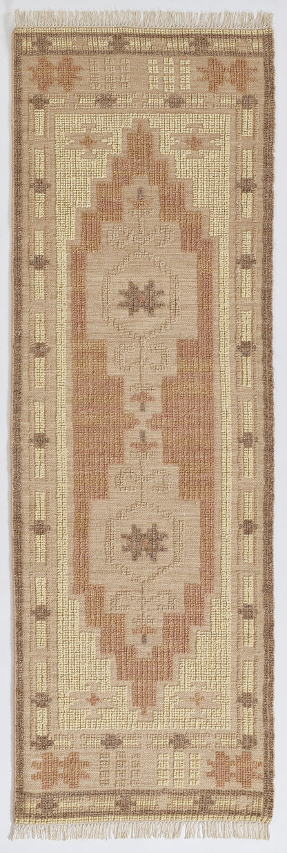 Neutral-toned runner rug with cream, tan and rose geometric motifs and fringed ends.