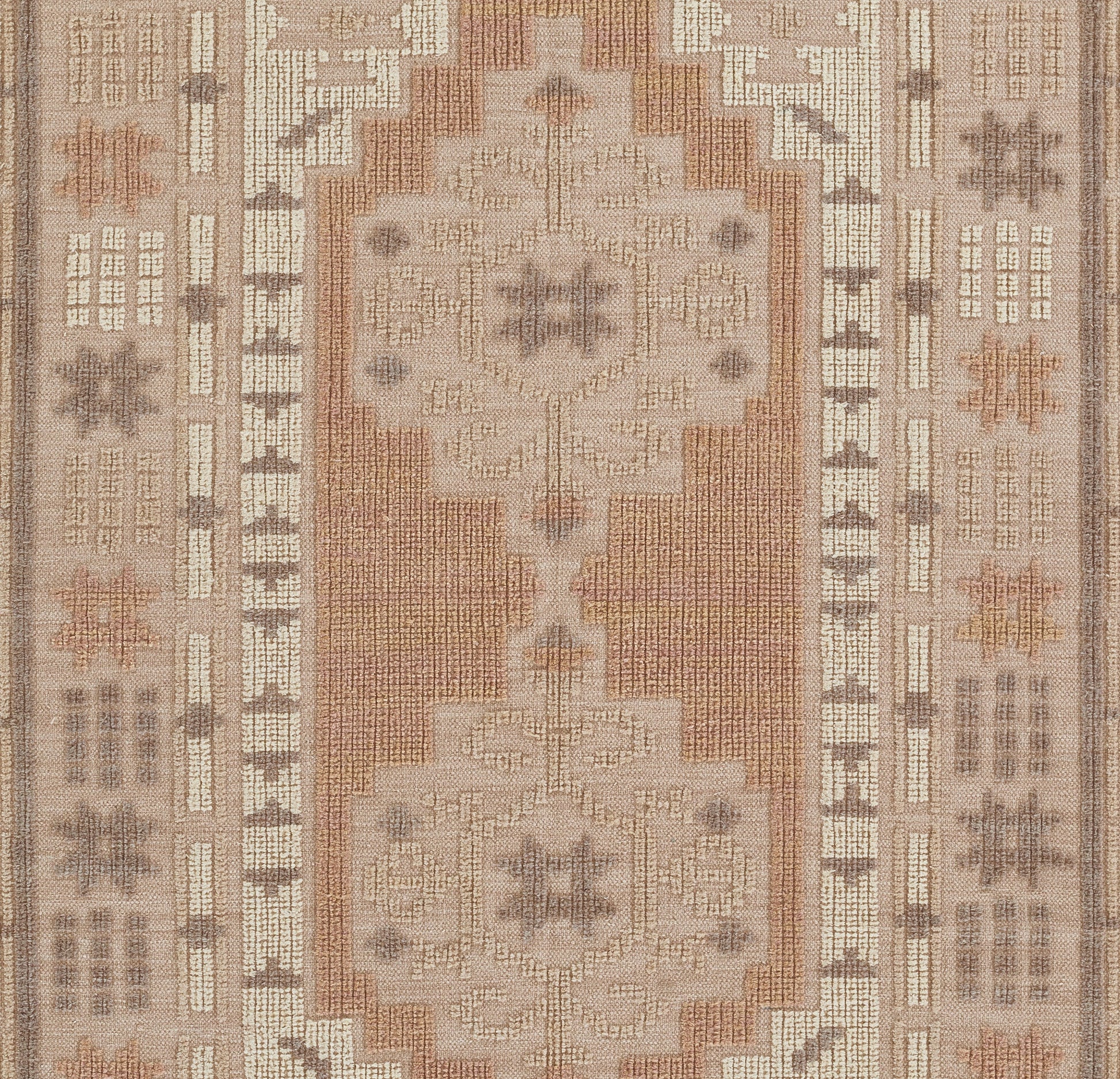 Rectangular oriental rug with two large cream medallions on a rust field, framed by beige and taupe geometric borders.