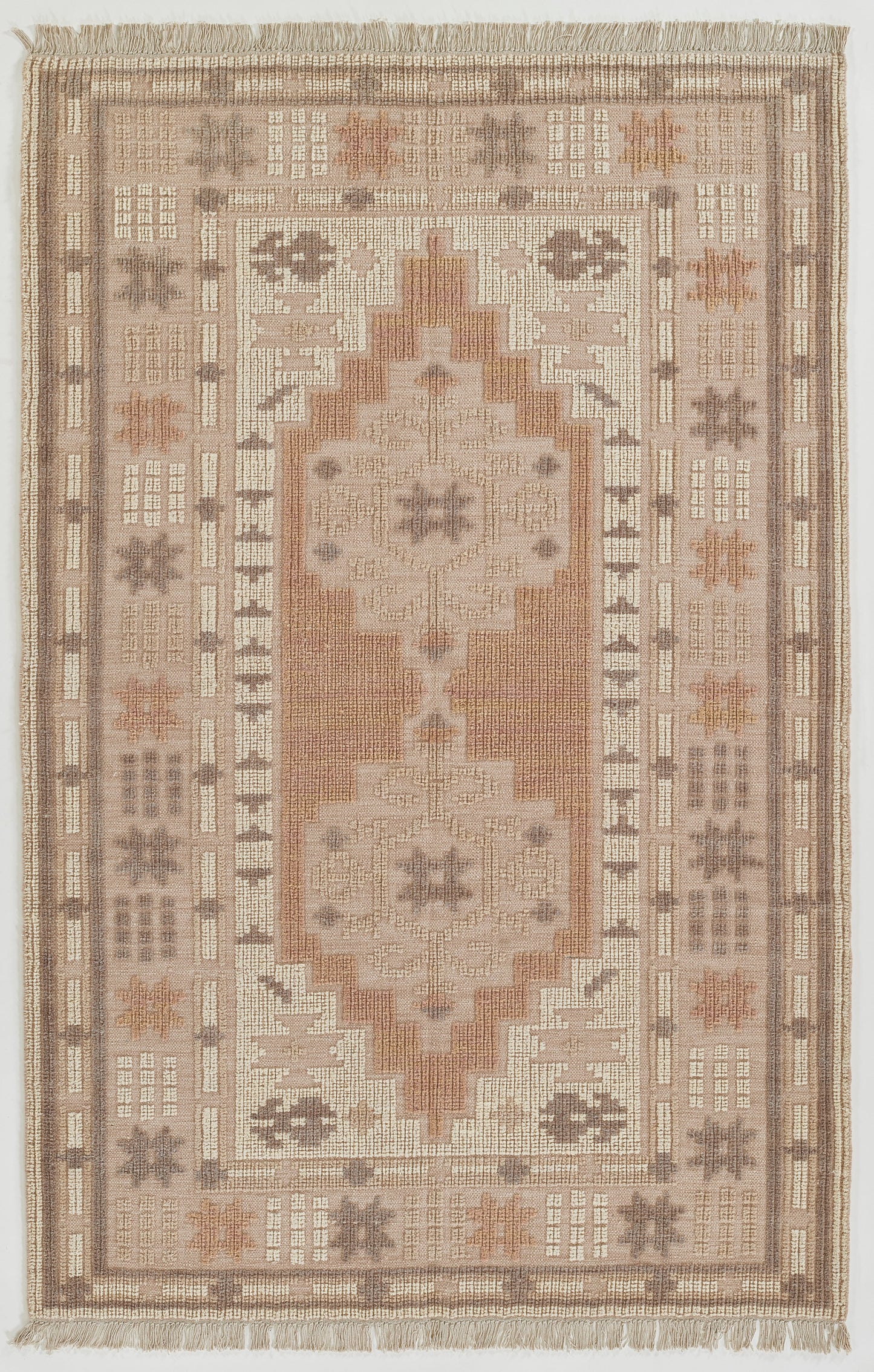 Persian-inspired flatweave rug in neutral taupe, ivory, peach & blush tones with central medallion and fringed edges.