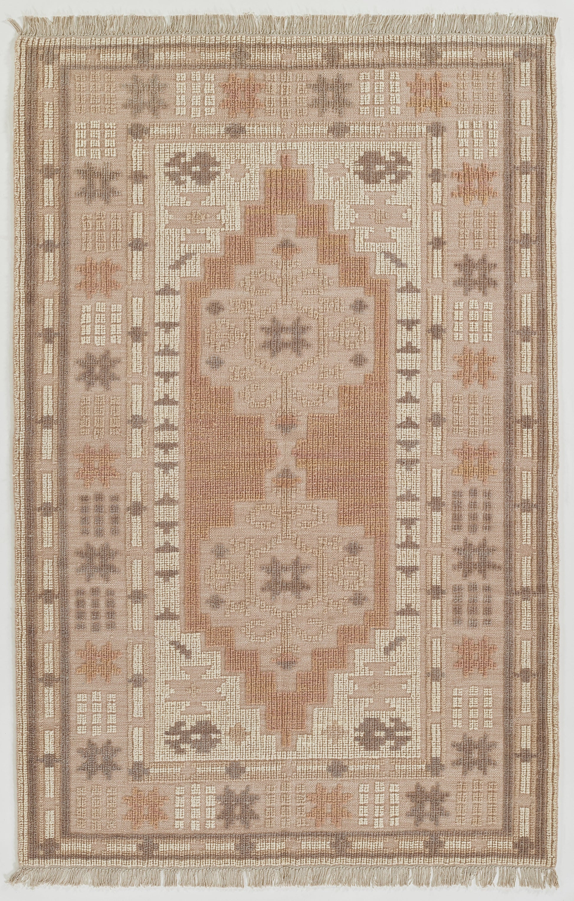 Persian-inspired flatweave rug in neutral taupe, ivory, peach & blush tones with central medallion and fringed edges.