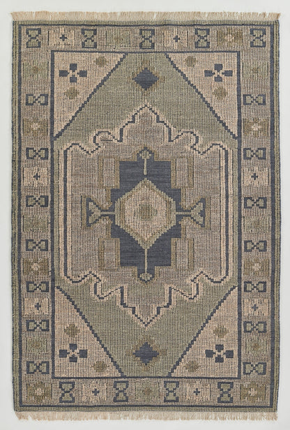 Geometric rug with dusty blue and tan palette, central diamond medallion, stepped arches, and a bordered frame with fringe.