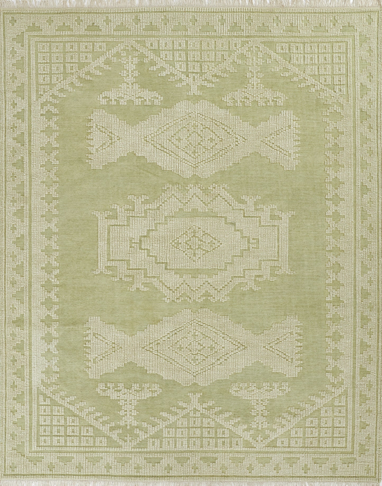 Olive green woven rug with cream geometric medallions, intricate border and fringed edges; tribal-style decor.