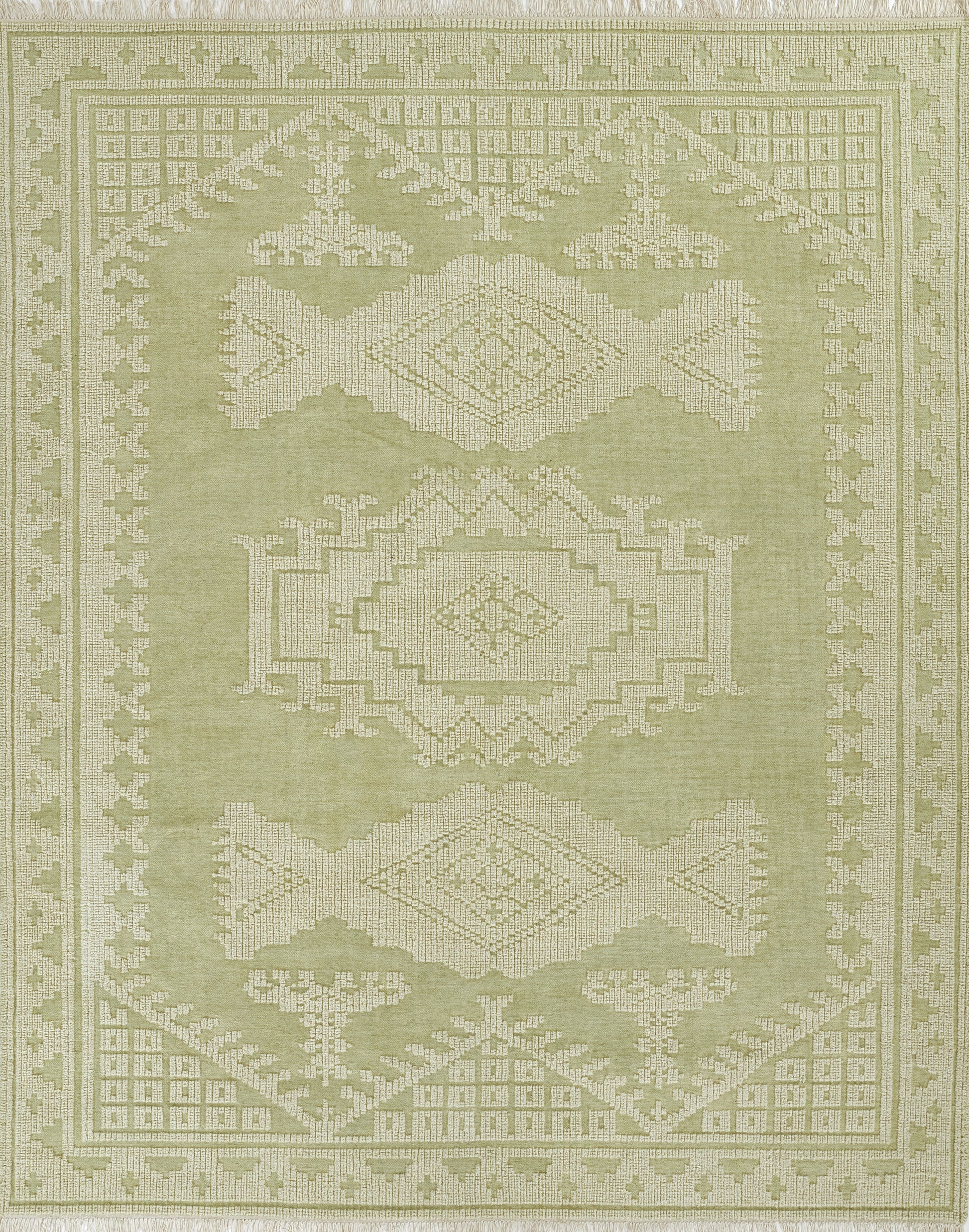 Olive green woven rug with cream geometric medallions, intricate border and fringed edges; tribal-style decor.