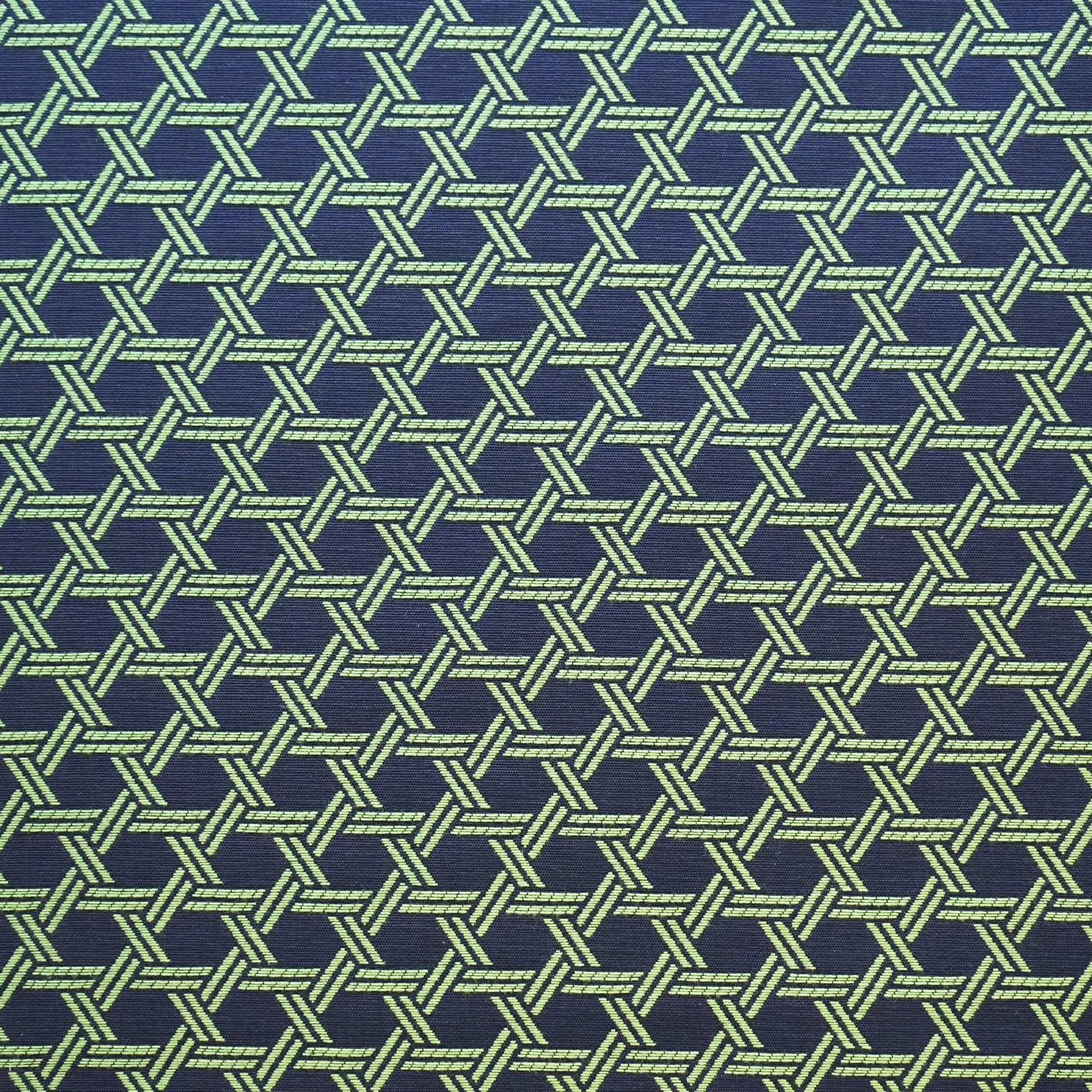 Blue jacquard fabric with an interlocking geometric lattice pattern; woven texture.
