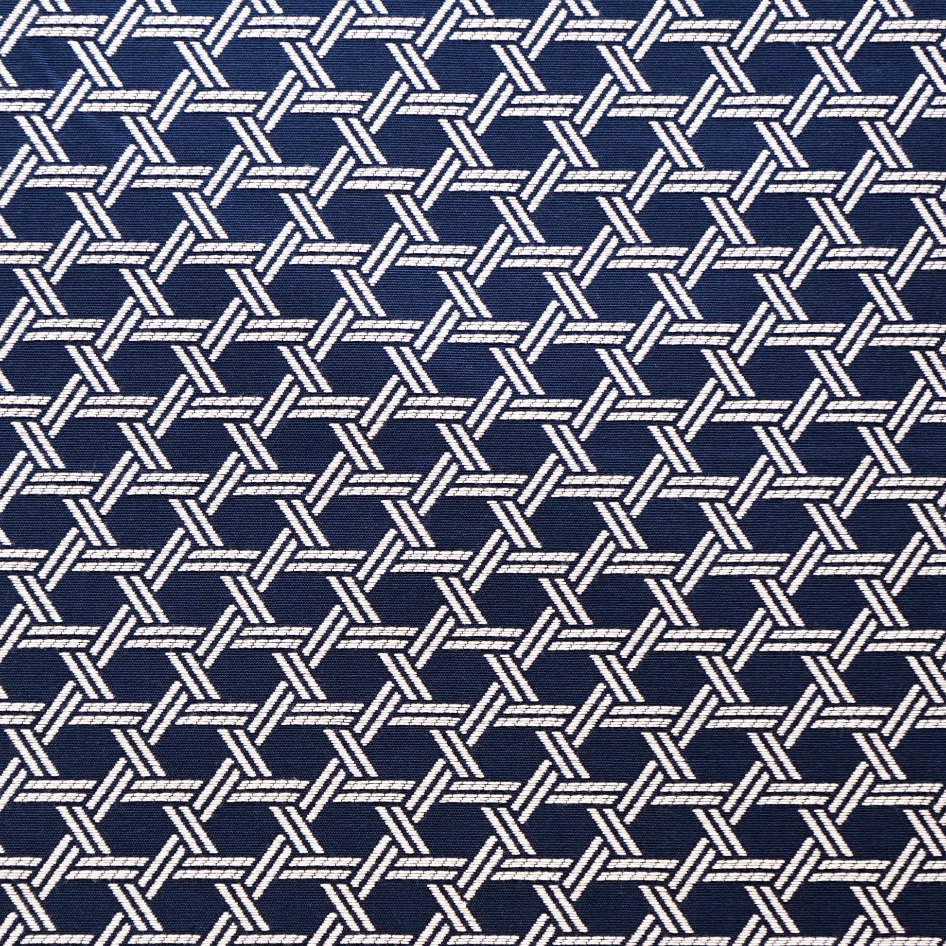 Navy fabric with repeating white braided lattice pattern; rope-like interlocking motif.