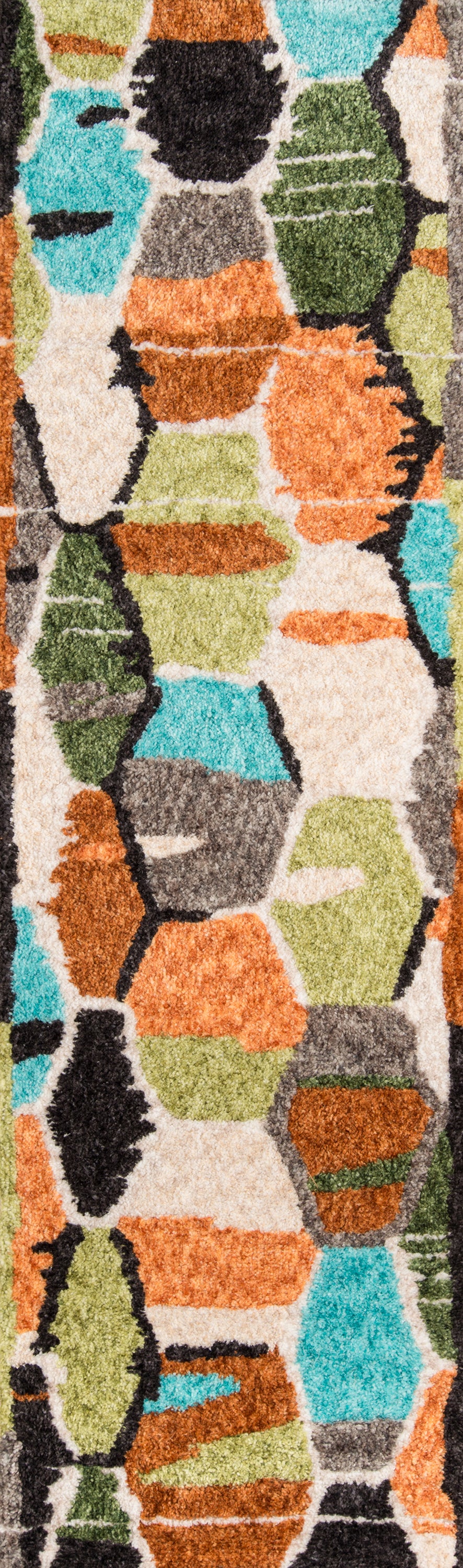 Colorful shag rug with irregular mosaic blocks in orange, lime green, turquoise, beige and black outlines.