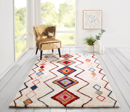 Gold sequin chair beside a colorful geometric diamond rug in a bright modern living room.