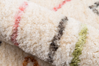 Cream shag rug with multicolor stripes in pink, gray & green; plush high-pile, cozy living room accent.