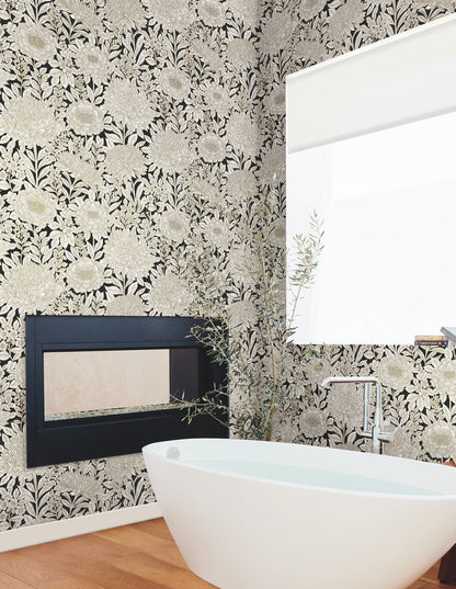Black and gold floral wallpaper with intricate blooming flowers, delicate leaves, and botanical branches. Wood Block Blooms designer wallpaper for elegant bedrooms, dining rooms, powder rooms, and statement walls.