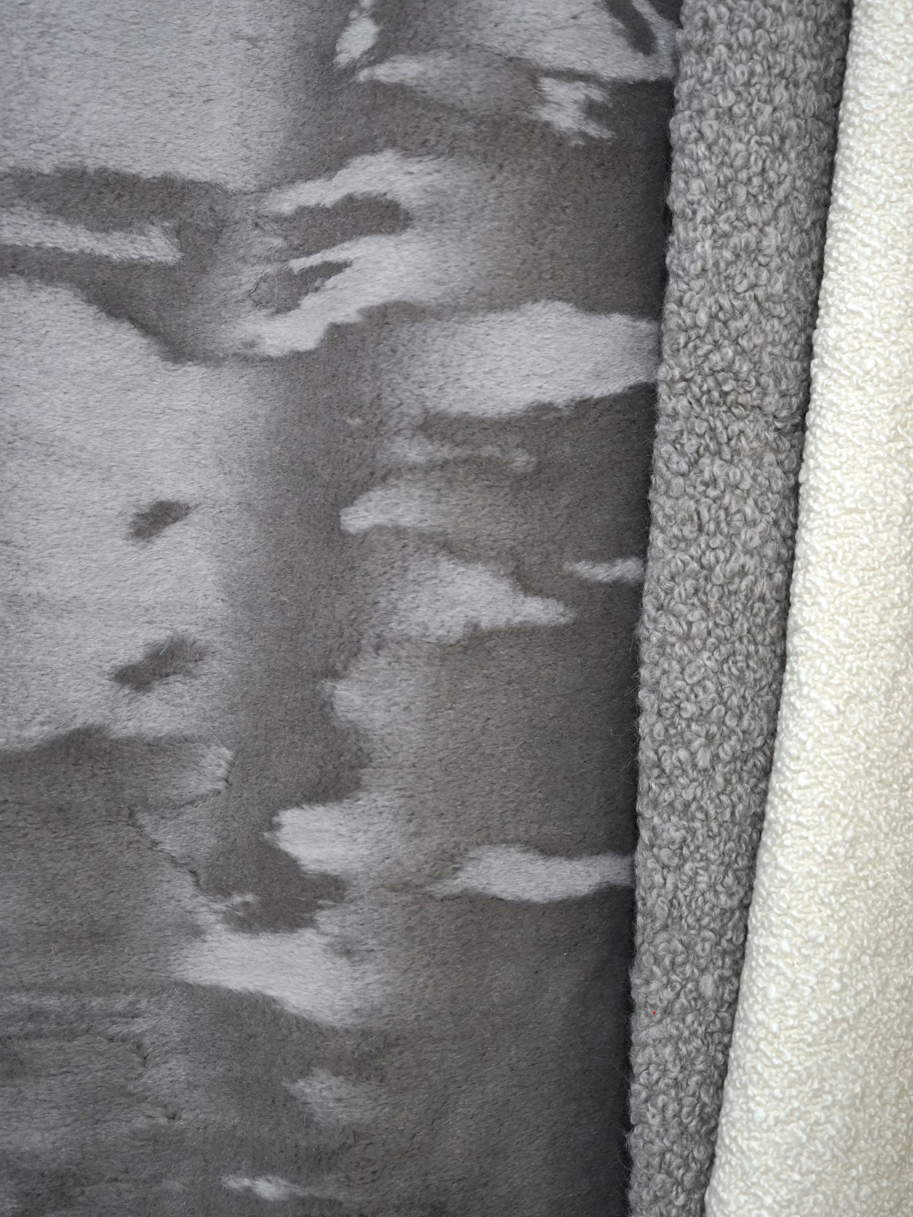 Close-up of ash brown mouton boucle fabric swatch with a multi-textured surface.