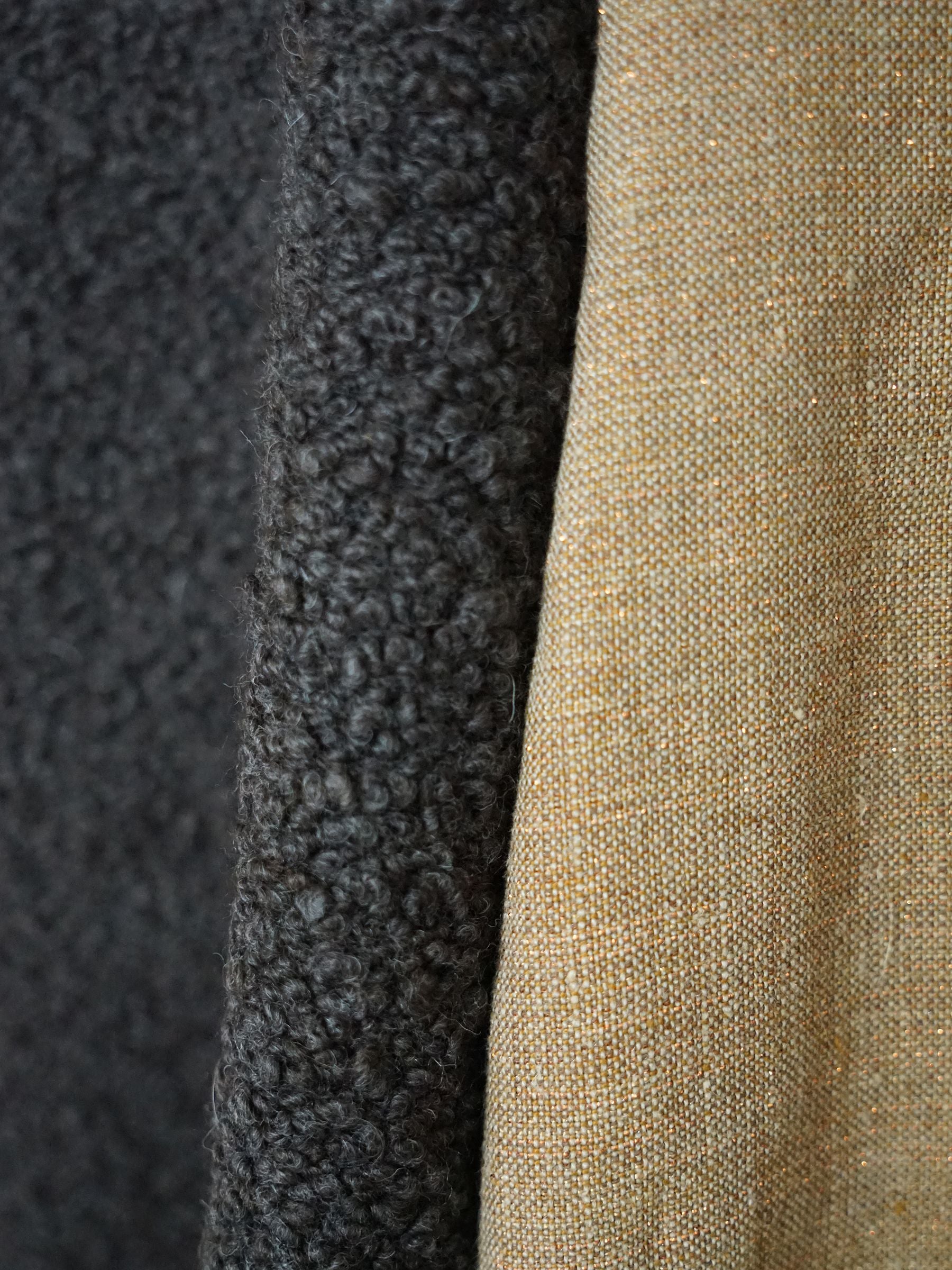 Close-up of ash brown mouton boucle fabric texture.