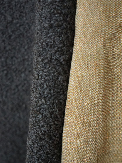 Close-up of ash brown mouton boucle fabric texture.