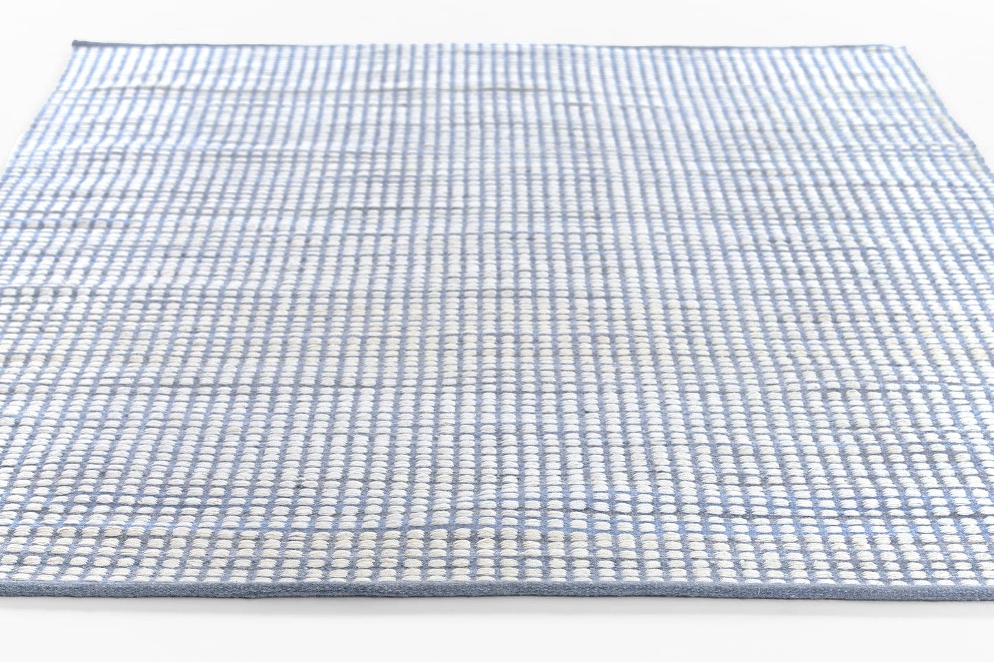 Blue and white woven flat-weave rug with a small checkered grid pattern, rectangular.