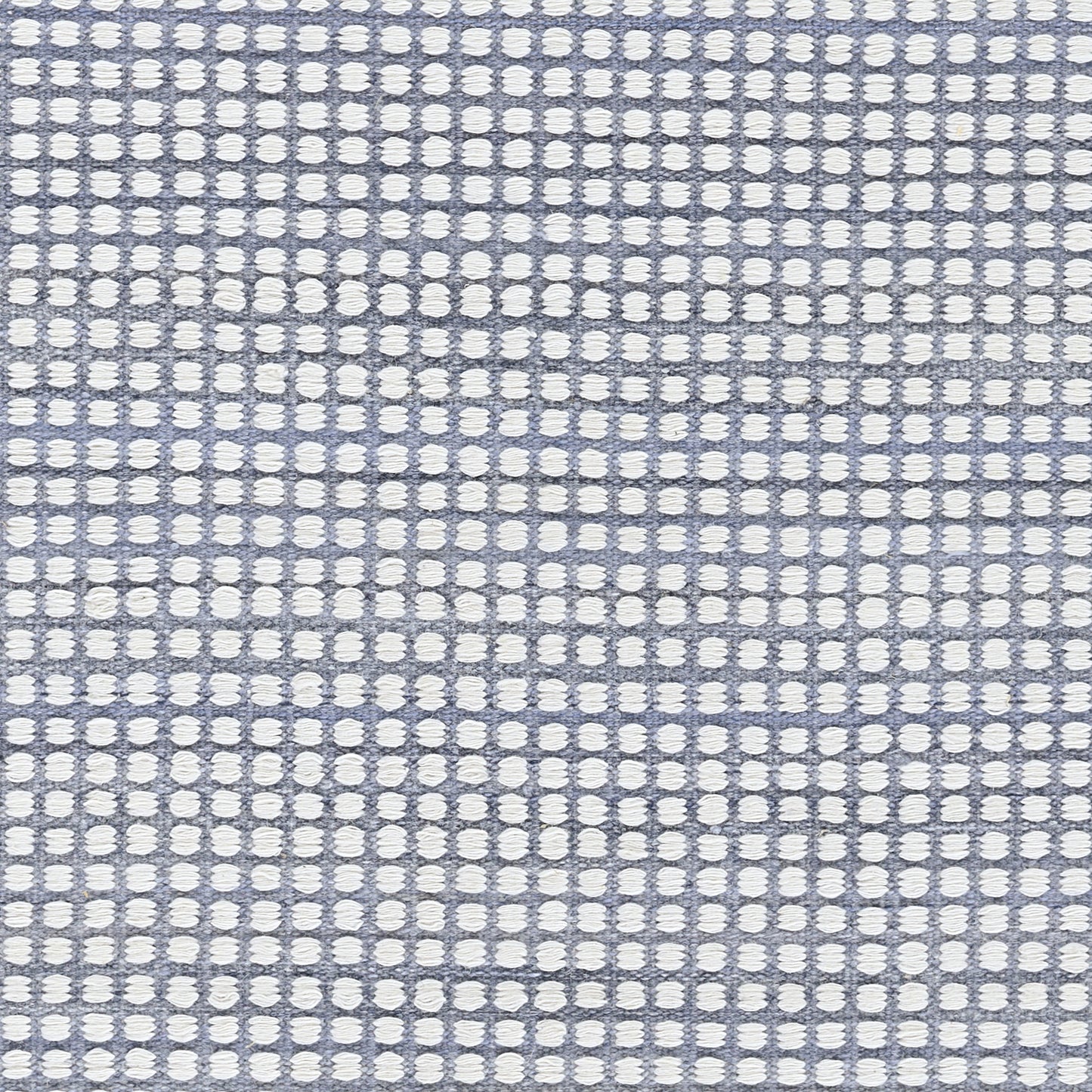 Blue woven rug with white circular dots in a grid pattern; 5' x 8' area rug; textured surface.