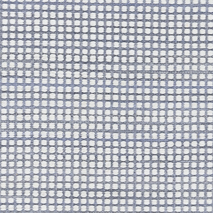 Blue woven rug with white circular dots in a grid pattern; 5' x 8' area rug; textured surface.