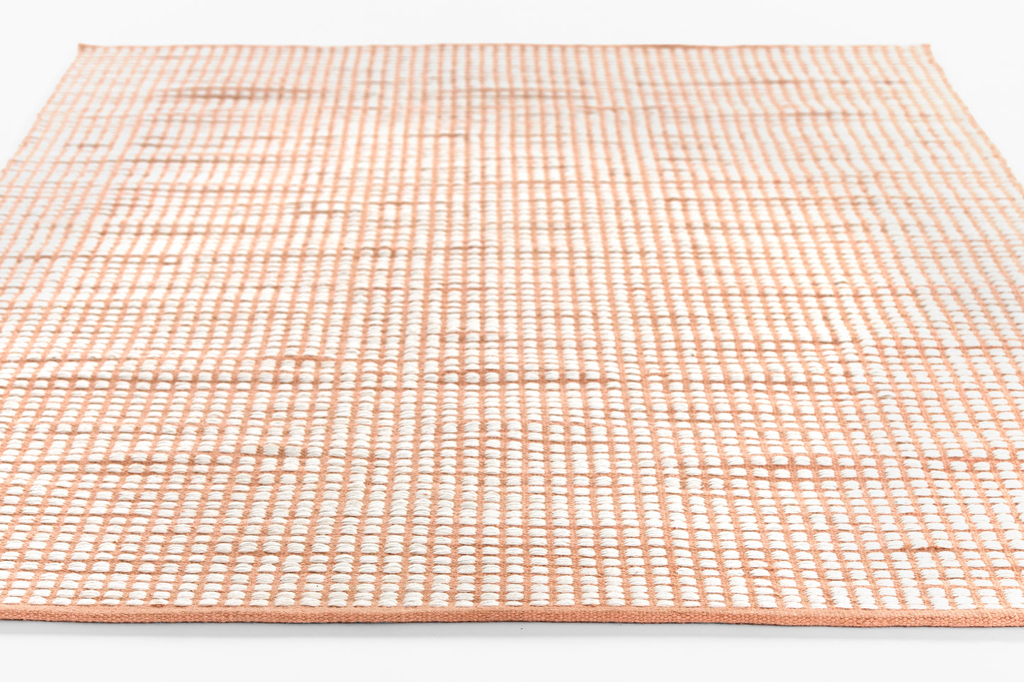 Peach-pink flatwoven rug with white grid pattern, 2' x 3' rectangular area rug.