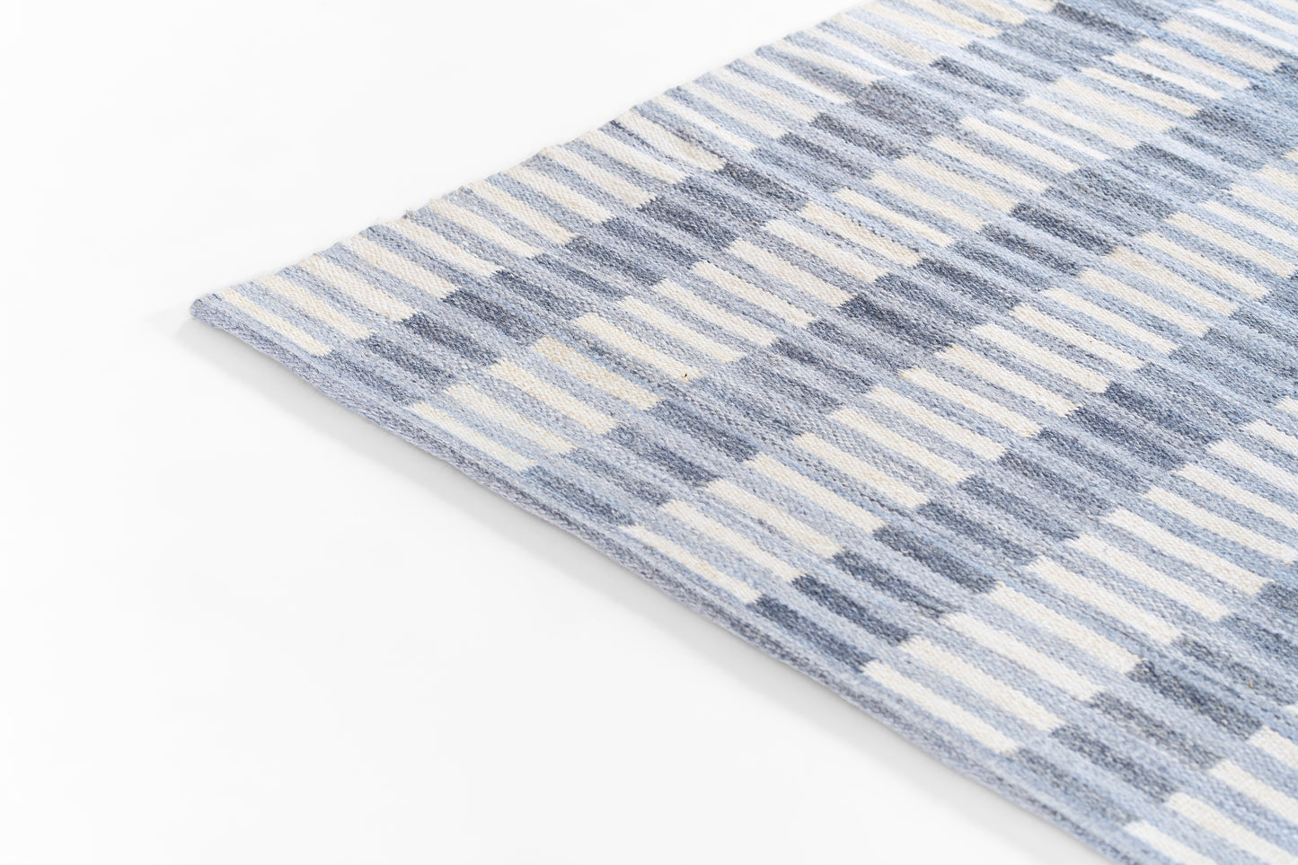 Blue striped woven rug, rectangular, soft cotton texture, casual coastal style.