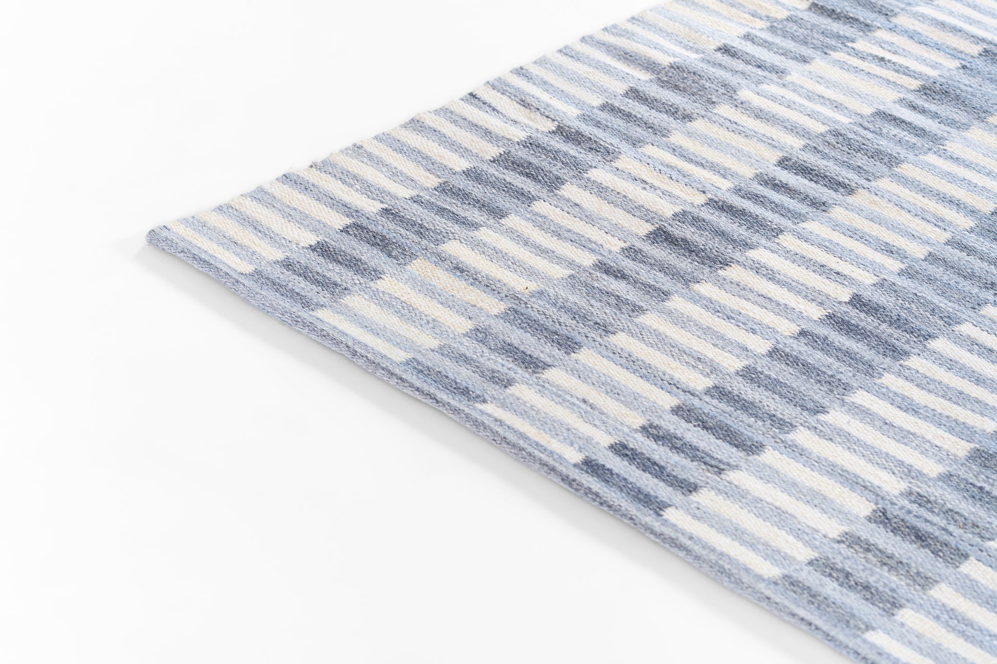 Blue striped woven rug, rectangular, soft cotton texture, casual coastal style.