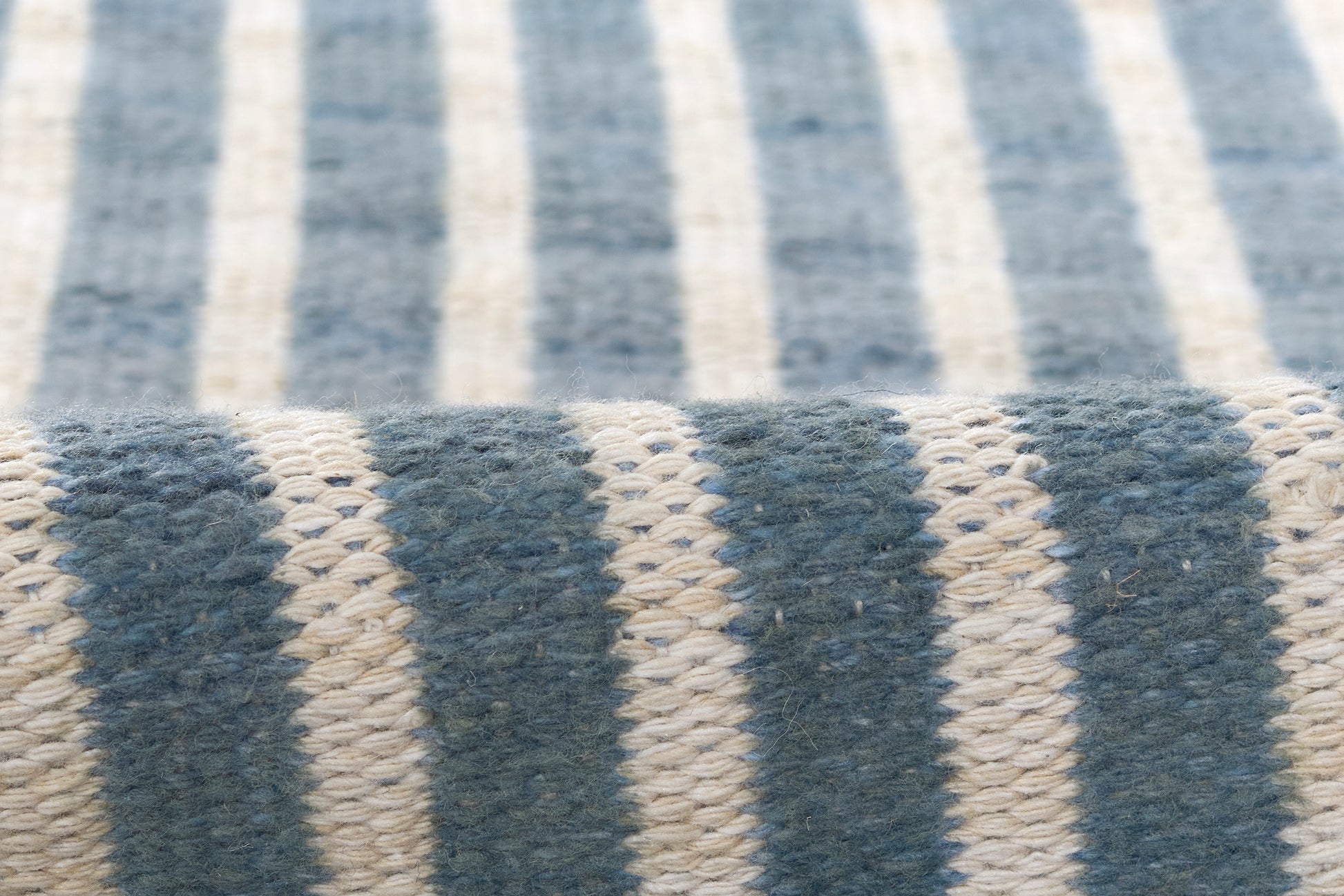 Blue & ivory striped woven rug with chunky knit texture, 5' x 8'.