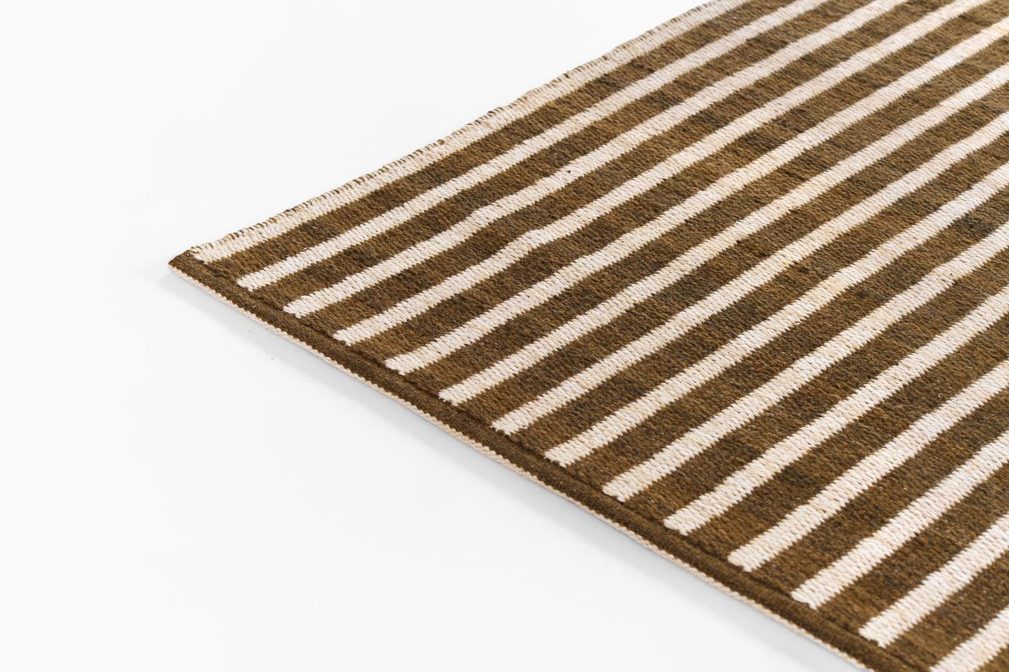 Brown and beige striped woven rug with fringed edges, rectangular casual living room rug.