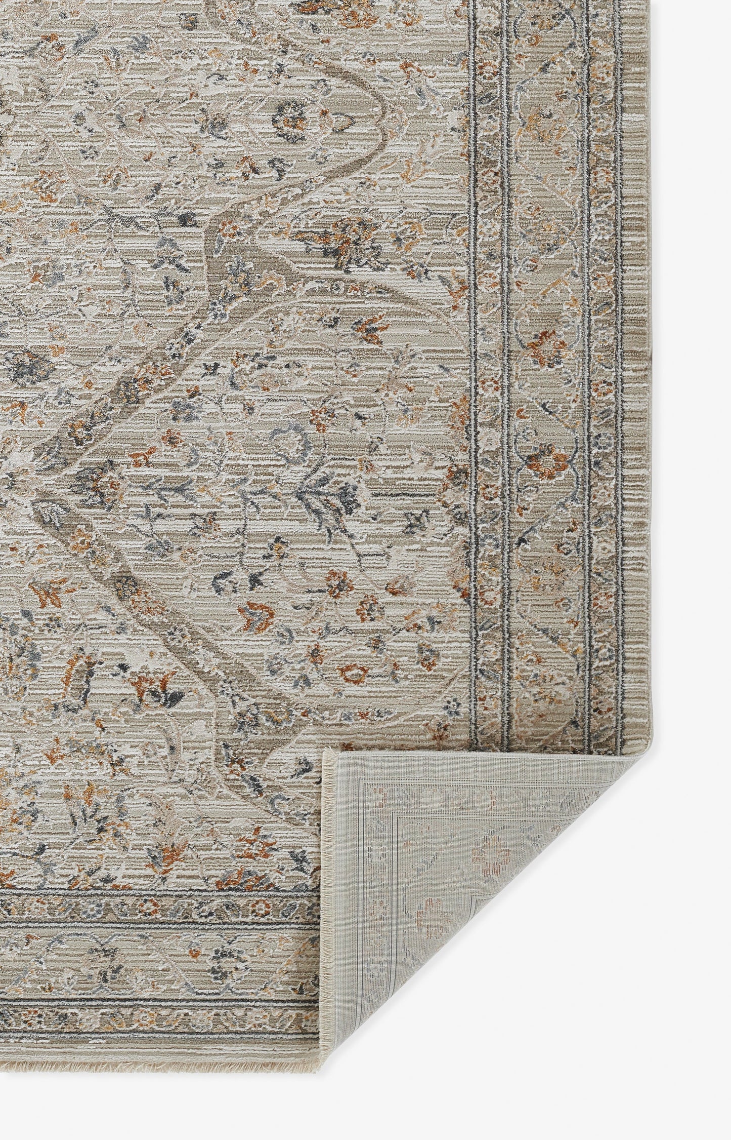 Beige traditional floral area rug with blue-gray vines and rust accents, ornate border; folded corner reveals backing.