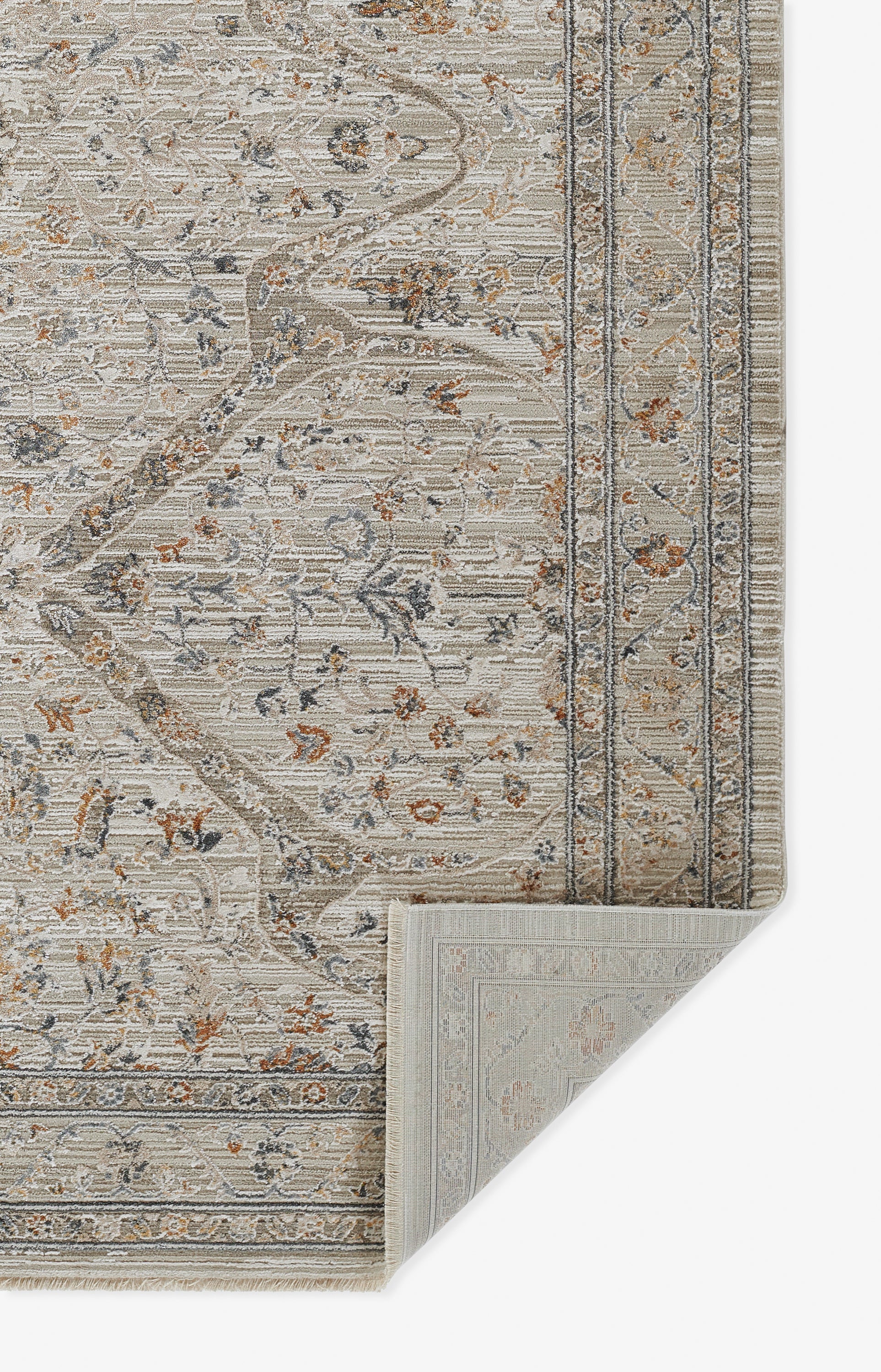 Beige traditional floral area rug with blue-gray vines and rust accents, ornate border; folded corner reveals backing.
